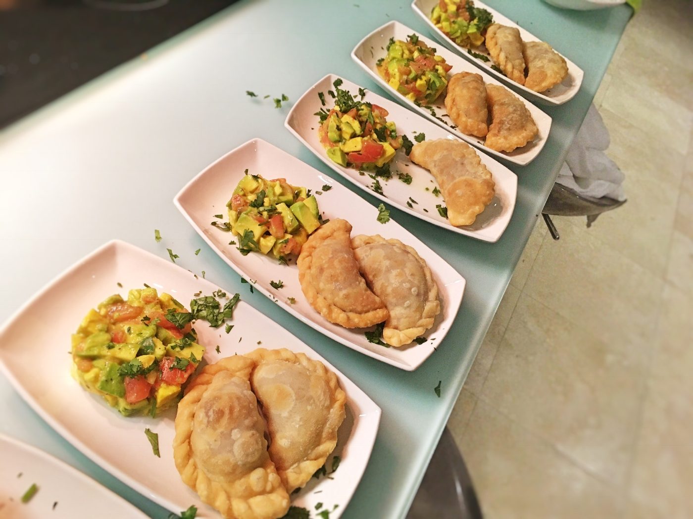 Fried pastechi served with fresh avocado and tomato salad